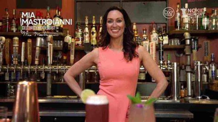 Mia Mastroianni as a bartender
